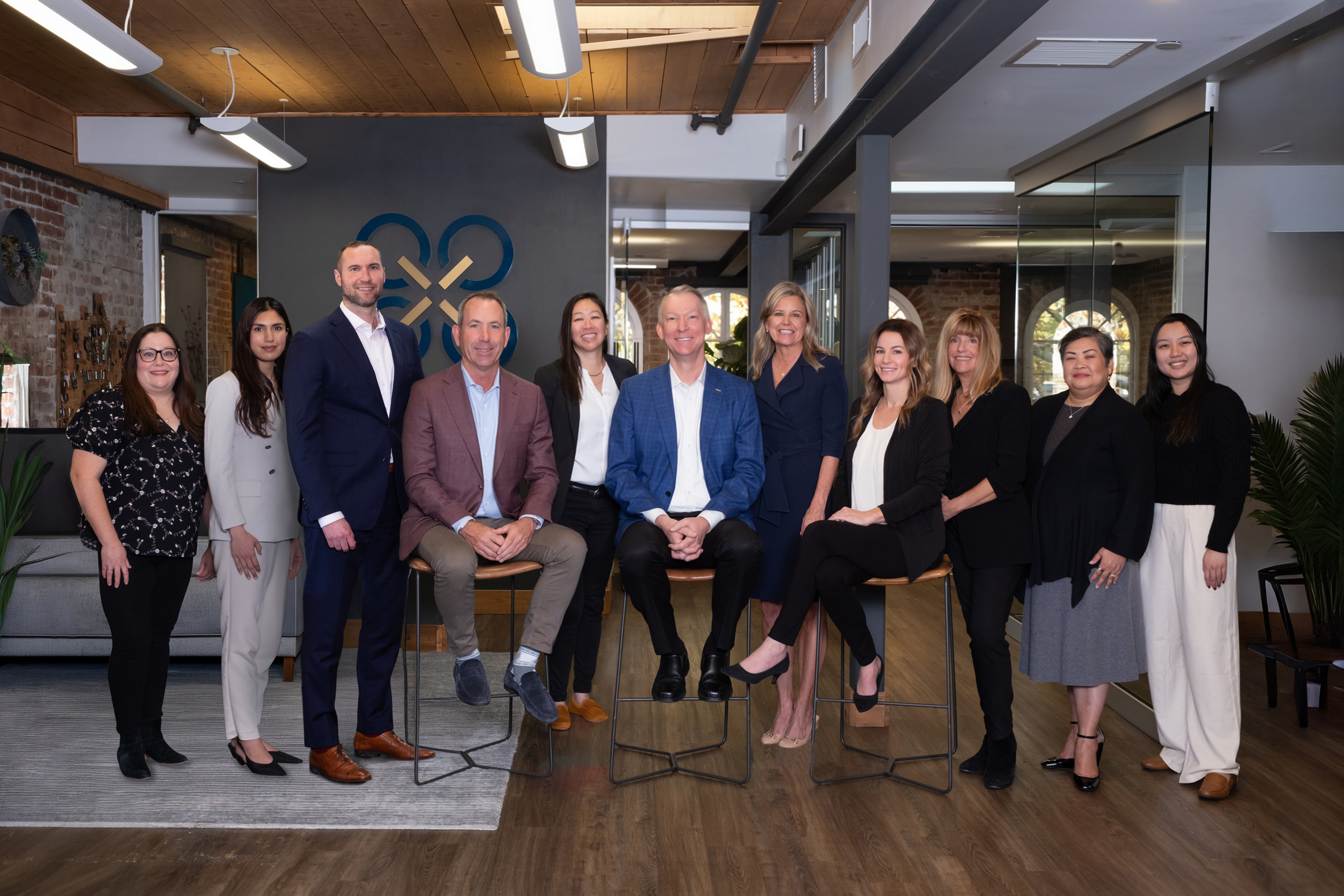A team shot of Quorum Private Wealth in their office showing Amanda Miller, Ash Hassan, Adam Zielske, Mike Barry, Melissa Yue, Kelly Milligan, Sue Schaeffer, Courtney Rapa, Barbara Prosser, Rica Tanod, and Michelle Le.